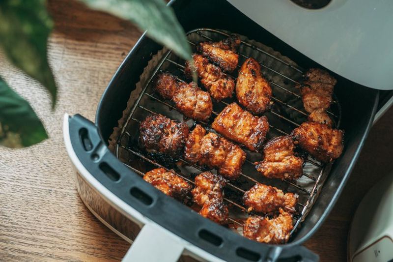 Air fryer basket with grilled chicken